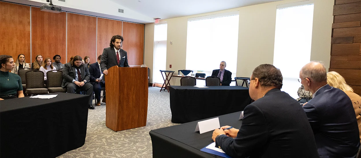 male student presents an oral argument in a moot court competition