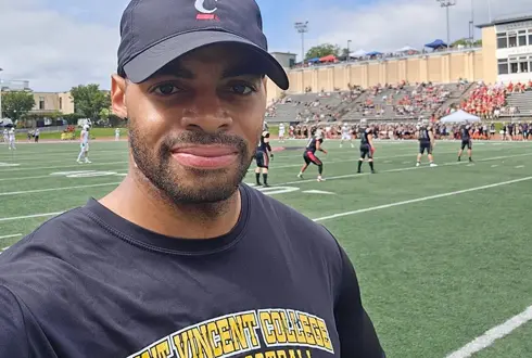 McKenna school alumn stands on an athletic field