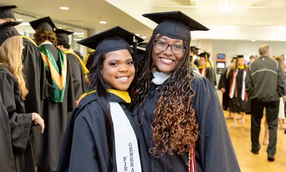 portrait of two students in cap and gown