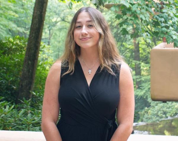 Gabbie Milcoff at Fallingwater outdoors with waterfall in the background