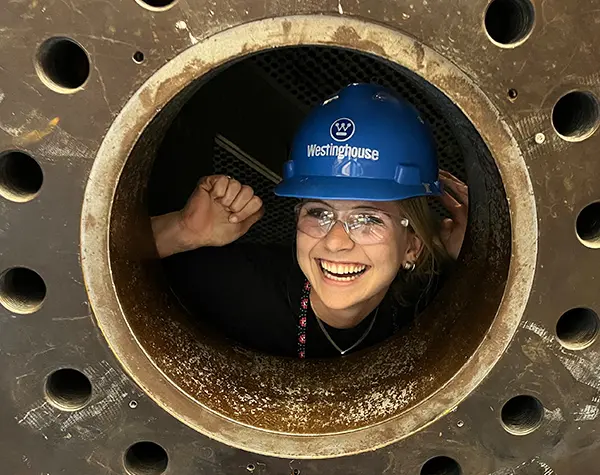 Photo of Sydney Green inside a steam generator mockup at Westinghouse Electric