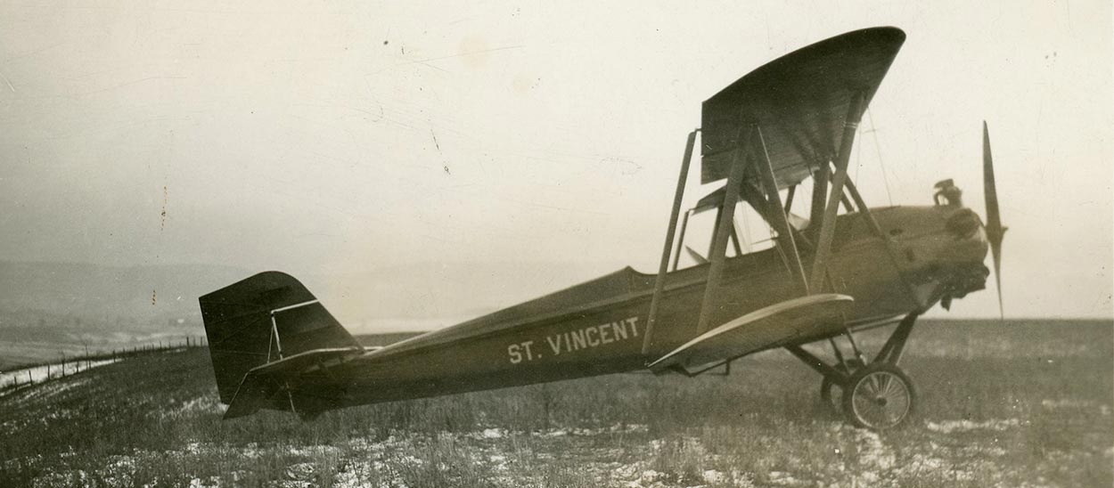 old photo of the Saint Vincent bi-plane sitting in a grassy field