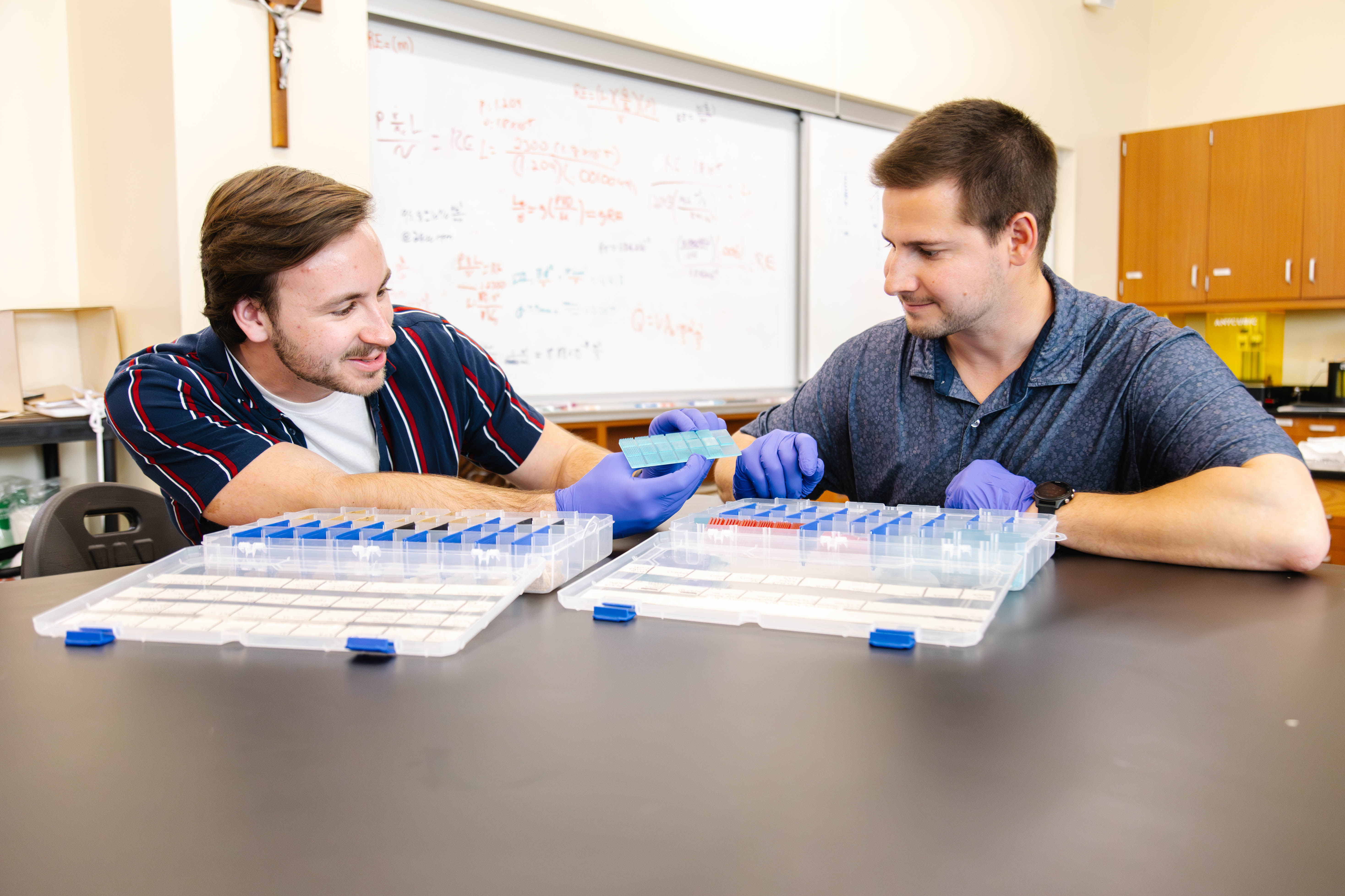 LATROBE, PA – Dr. Adam Wood, assistant professor of engineering in the Herbert W. Boyer School of Natural Sciences, Mathematics and Computing at Saint Vincent College, received a $200,000 grant from the National Science Foundation (NSF) to fund research on water desalination.  Dr. Wood’s project, which is entitled "Carbon electrodes with controlled surface topology for desalination and water disinfection," is studying how to use bread to produce fresh, drinkable water. A significant portion of the grant will enable undergraduate students to work on the project over the summer and through the upcoming academic year.   “NSF grants are very competitive and this award speaks to the high quality and potential impact of the research conducted by Dr. Wood,” said Dr. Stephen Jodis, dean of the Boyer School. “I am very excited for Dr. Wood and the opportunities for our students who will work with him on this project.”  Over the past two years, Dr. Wood and engineering student David Bujdos, C 24, of Munhall, have experimented with using whole wheat bread to create carbon electrons, which when charged by a power source can remove salt and other minerals from low-salinity water.   “You can hook it up to a solar cell, put it out in the sun and turn saltwater into pretty much freshwater, so it is a water-purification technique,” Dr. Wood said. “You can also use it to kill bacteria in the water. We’re not there yet, but we’ve got it started and we’ve proved that this works.”  The process on a large scale could someday lead to an effective, accessible and less expensive way of purifying water for cities, municipalities and people all over the world.  “We’re not at that stage yet,” Bujdos said. “But with more funding comes more resources and more workers to be able to advance the project.”  PHOTO: SVC engineering student David Bujdos (left) and Dr. Adam Wood 