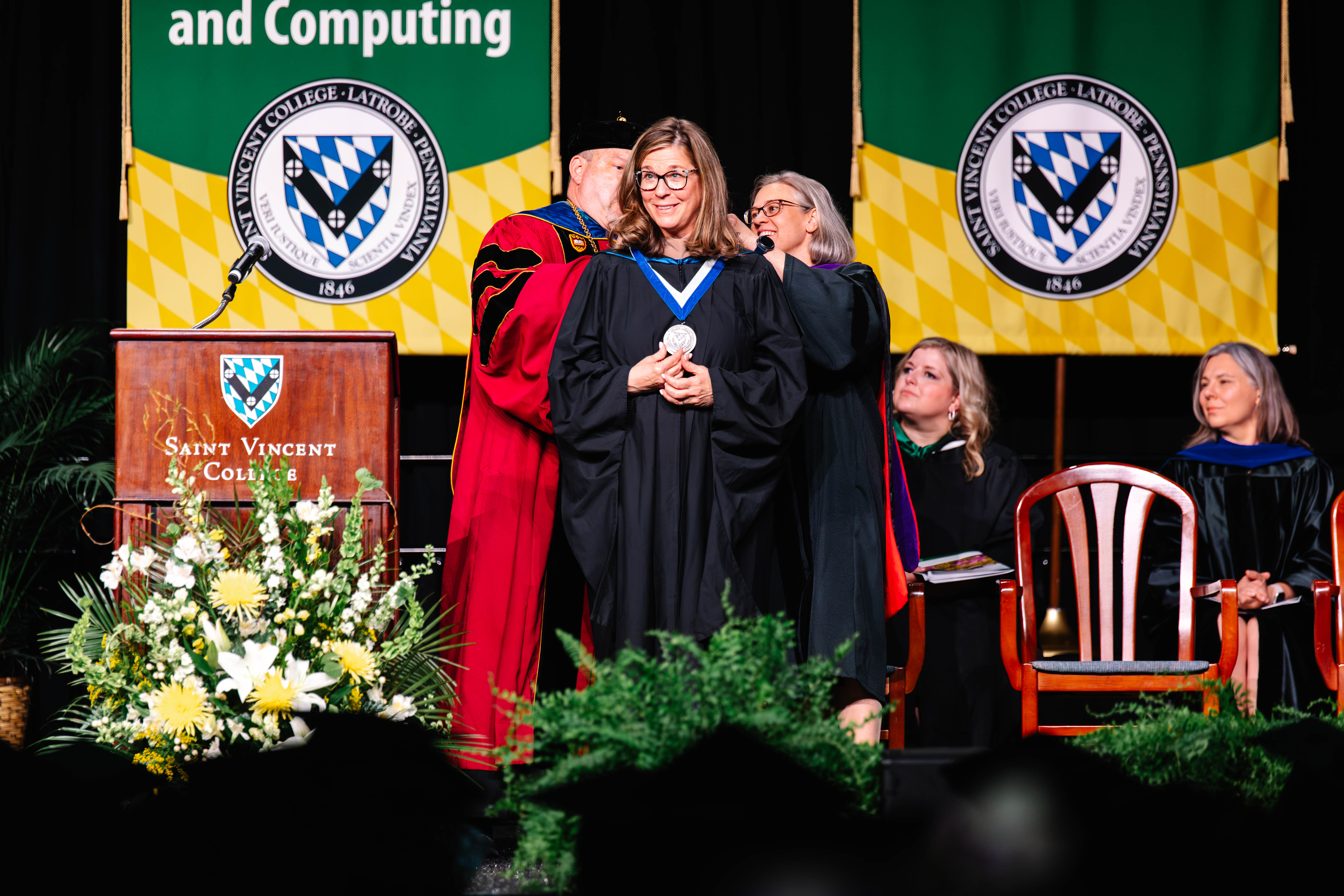 Ms. Susan Baker Shipley (center) president of the Pennsylvania, Ohio Valley and Mahoning region for Huntington Bank, receives the Presidential Medal of Honor from Rev. Paul Taylor, O.S.B., president of Saint Vincent College (left) and Ms. Kimberly M. Colonna, Esq., Board of Directors vice chair (right)