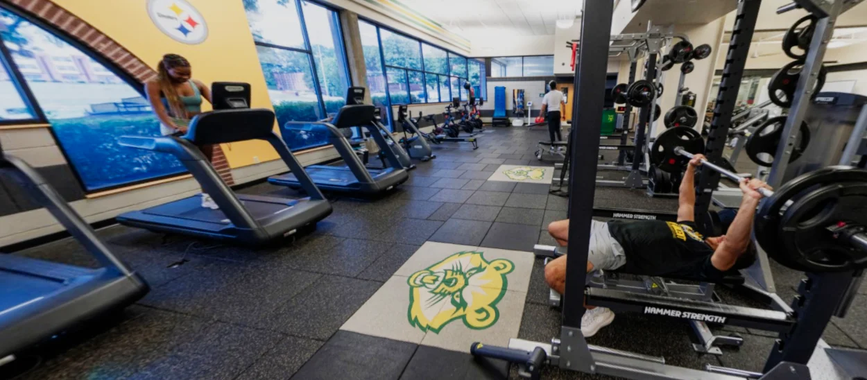 Interior of an athletic center with weight machines and bikes