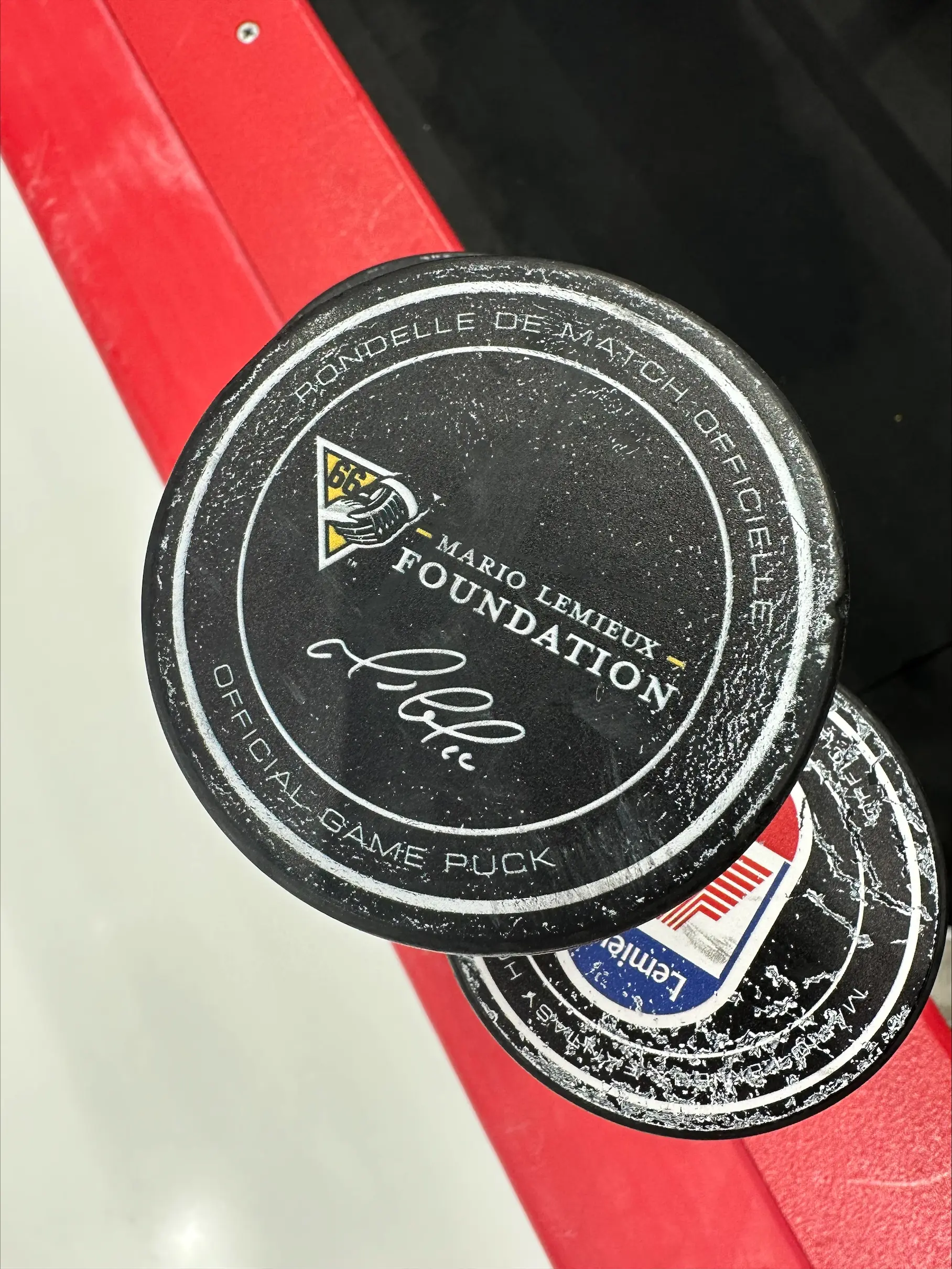 Official game puck featuring the Mario Lemieux Foundation logo and signed by Mario Lemieux.