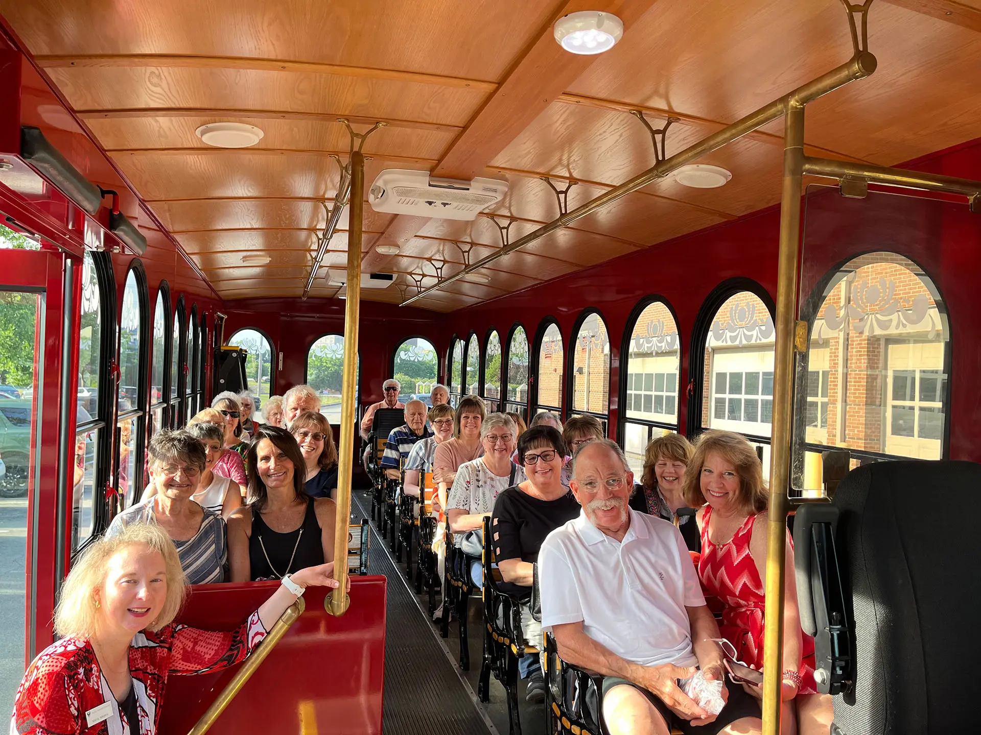 A groups of people sitting inside a trolley