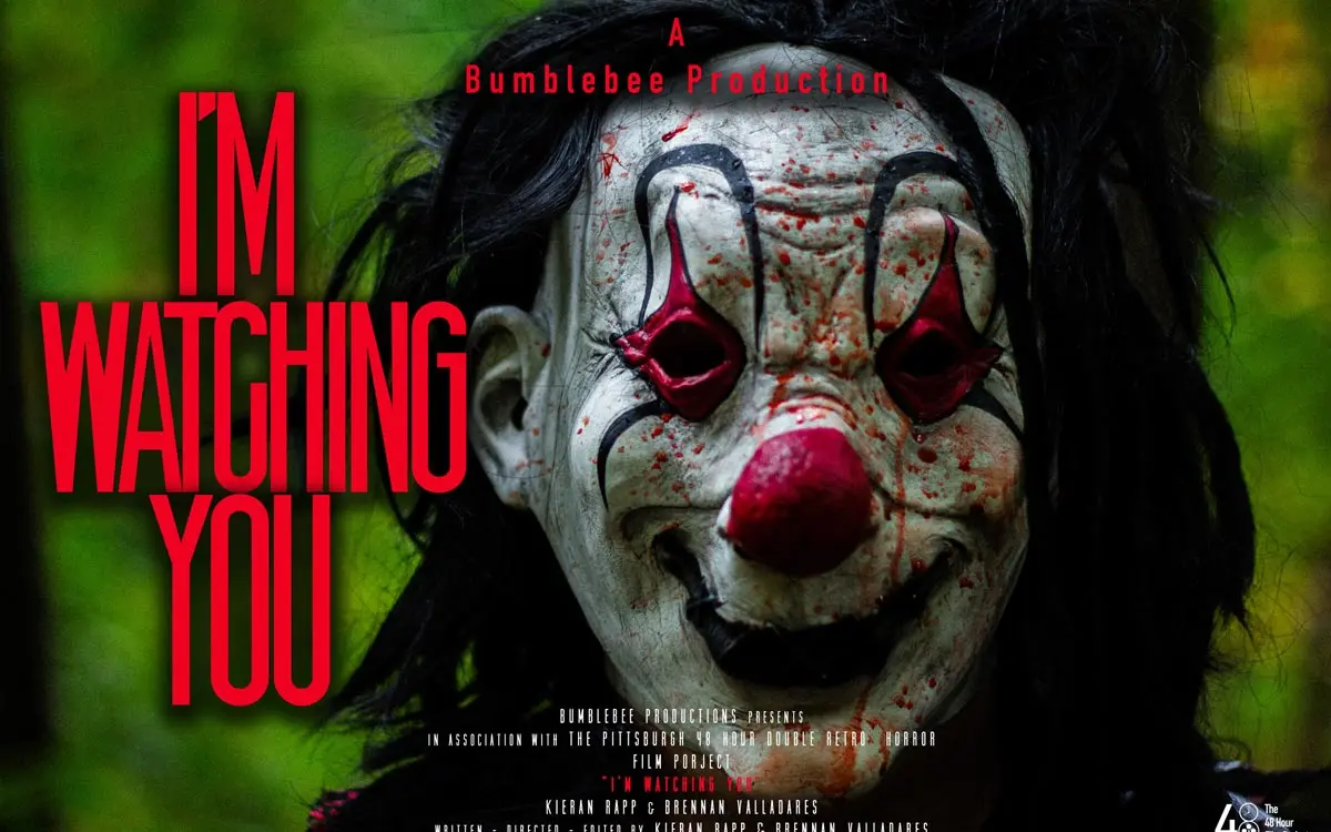 A promotional poster for a horror film featuring a menacing clown with a painted face and haunting expression. The bold text reads "I'M WATCHING YOU" prominently at the top.